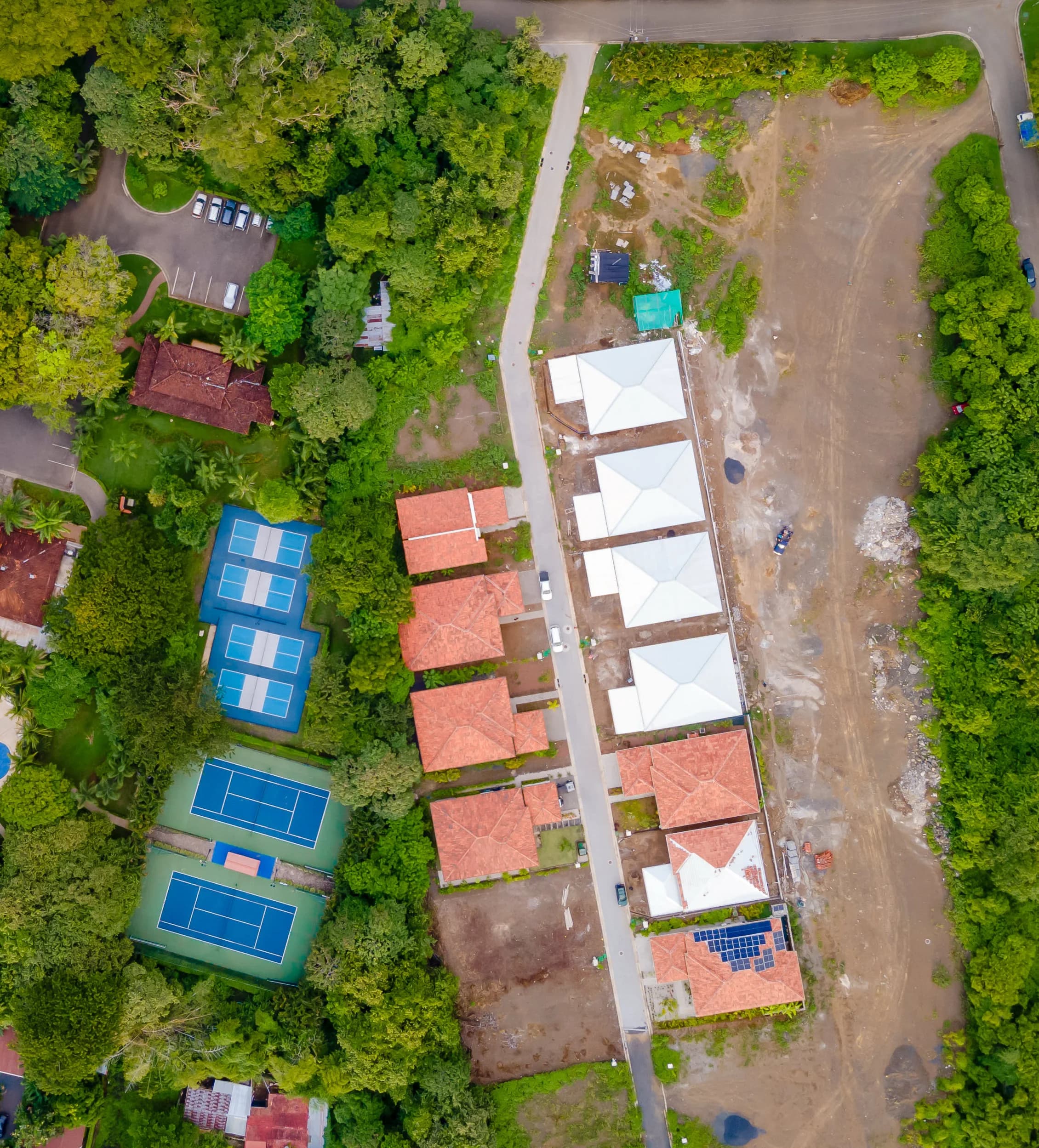 Aerial view of residential development with tennis courts